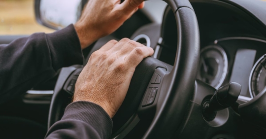 Male driver honking car horn in road rage incident